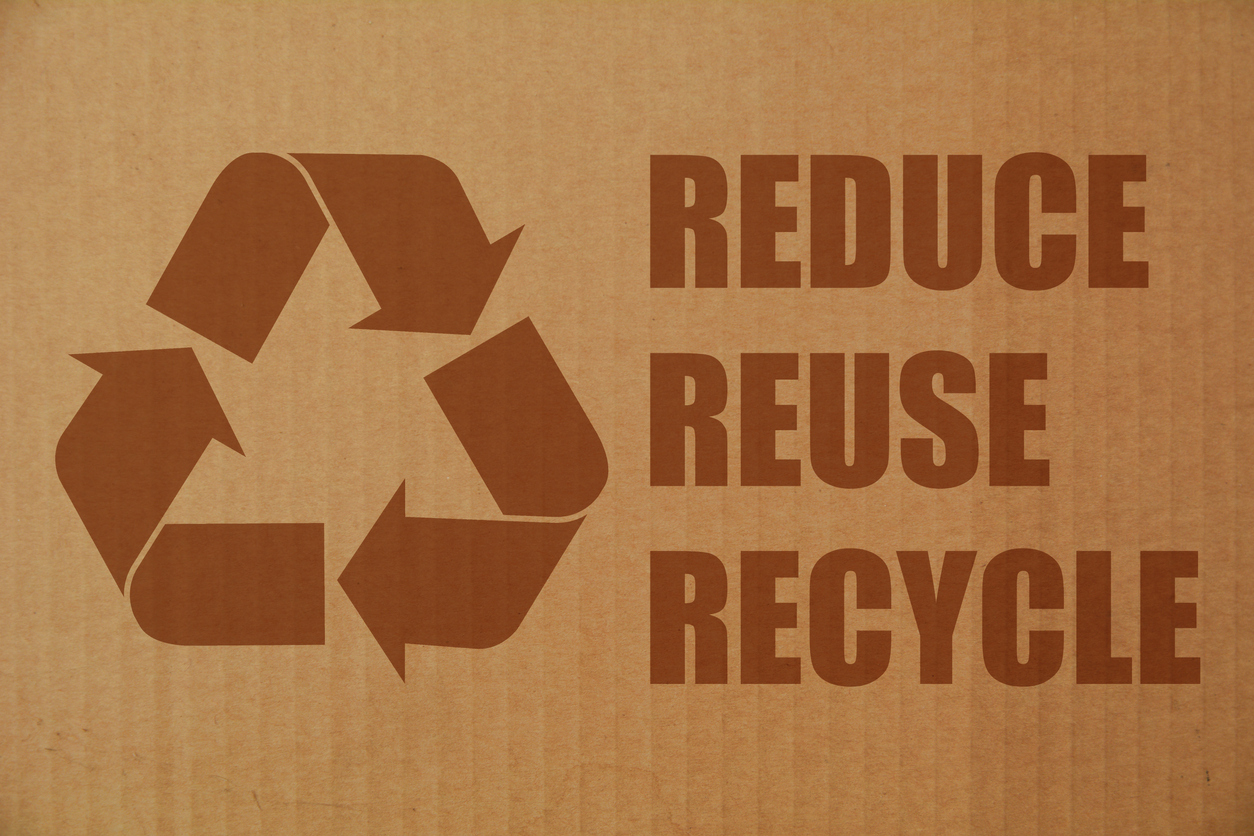 sustainable corrugated packaging — Recycling symbol and texts on cardboard background